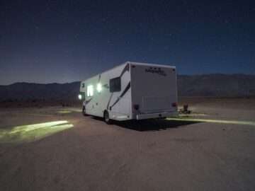 RV parked at night under a starry sky